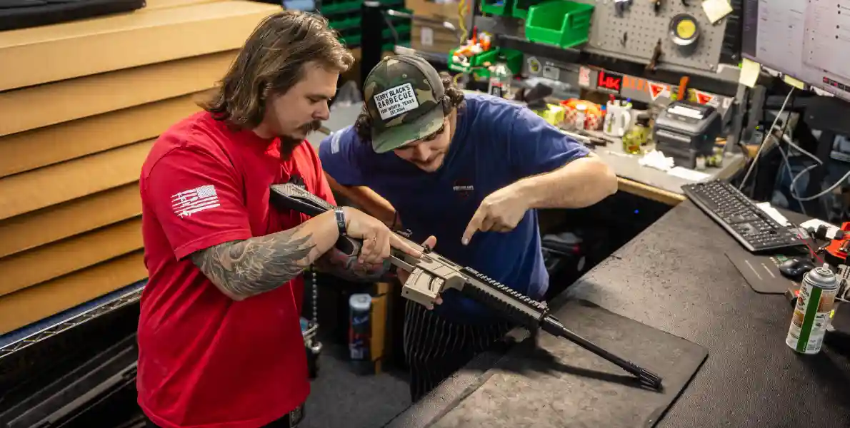 men inspecting rifle