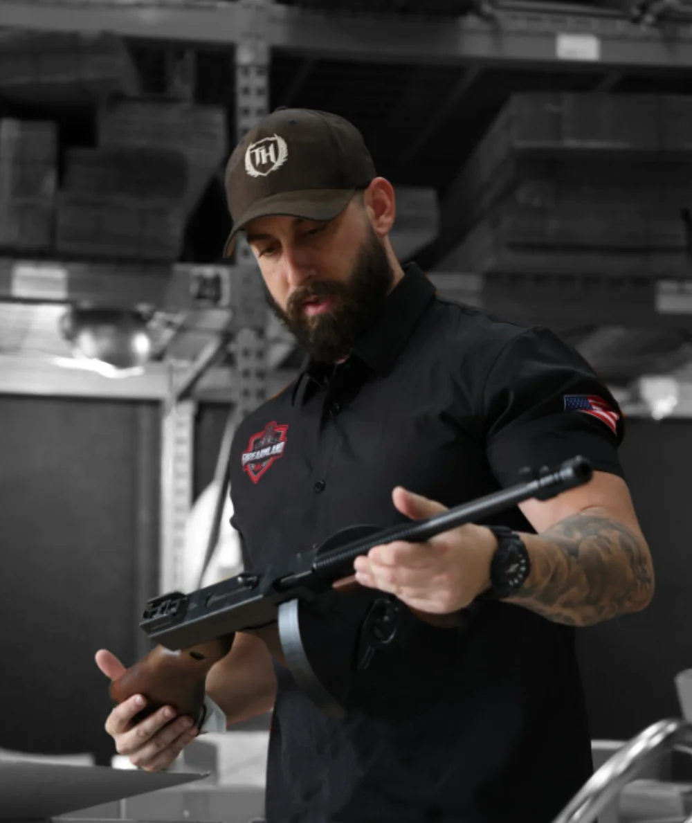 FirearmLand specialist inspecting a consigned Thompson-style firearm in our warehouse
